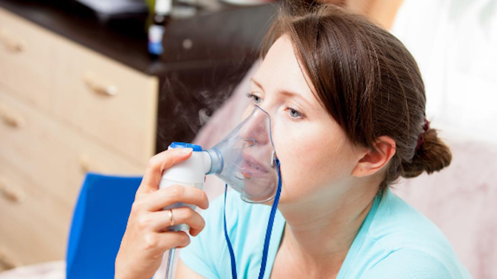 A Woman Using Nebulizer Treatment